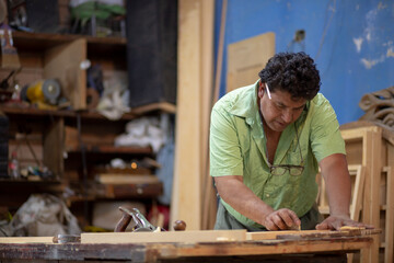 Mexican carpenter working in his workshop