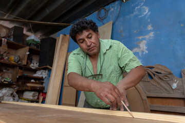 Mexican woodworker, carpenter working in his workshop