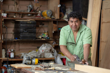 Portrait of a Mexican carpenter on his workshop