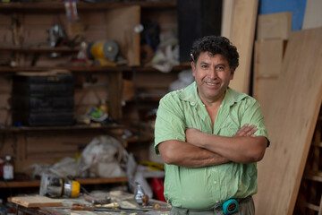 Portrait of a Mexican woodworker, carpenter on his workshop