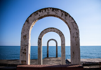 concrete arches lead to the sea