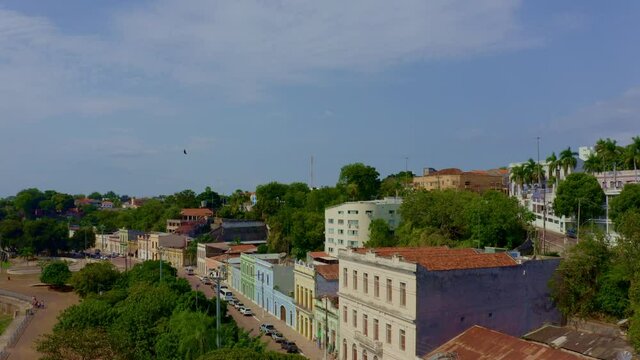 A large bird soars over the quiet city of Corumba, Brazil - aerial view