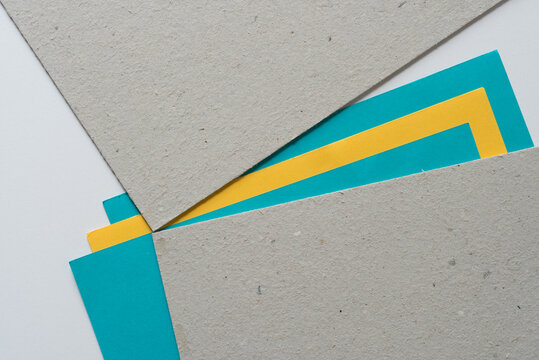 abstract paper composition - turquoise blue, yellow, and textured mill board with space for text