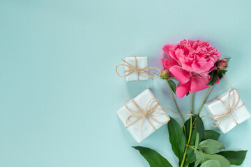 Bouquet of beautiful pink peonies with gift boxes in paper wrapping. Banner for congratulations or invitation.