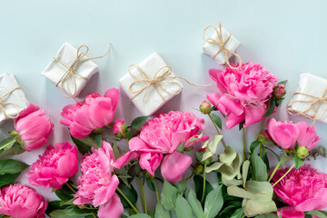 Bouquet of beautiful pink peonies with gift boxes in paper wrapping. Banner for congratulations or invitation.