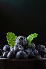 Blueberries in bowl dark background