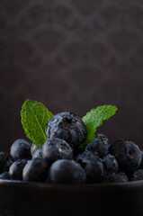 Blueberries in bowl dark background