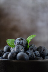 Blueberries in bowl dark background