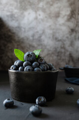 Blueberries in bowl dark background