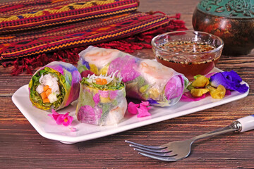 Spring rolls : Edible flowers spring rolls. Beautiful and delicious Thai cuisine. Colorful appetizer made from edible flowers, shrimps, rice noodle and organic vegetables wrapped with rice paper