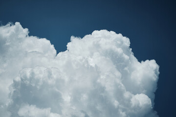Naklejka na ściany i meble White cloud formation over deep blue sky