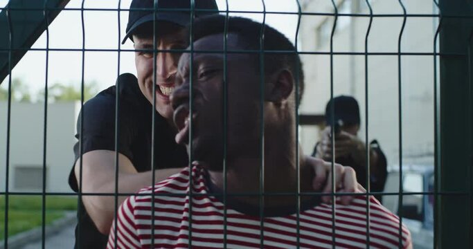 Police officer speaking to black man during arrest