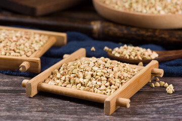 Raw uncooked buckwheat on wooden background