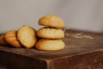 Stack of homemade cookies on wooden board. Baking in country kitchen.