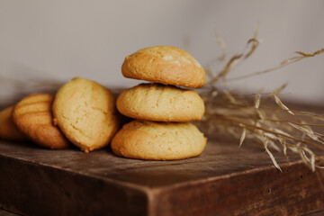 Stack of homemade cookies on wooden board. Baking in country kitchen.