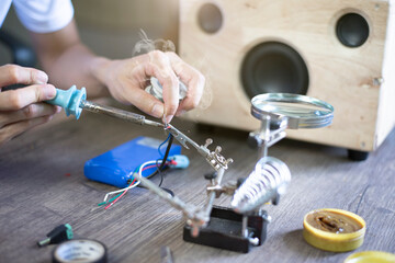 Electronic equipment repair, technician soldering wires, Close up.