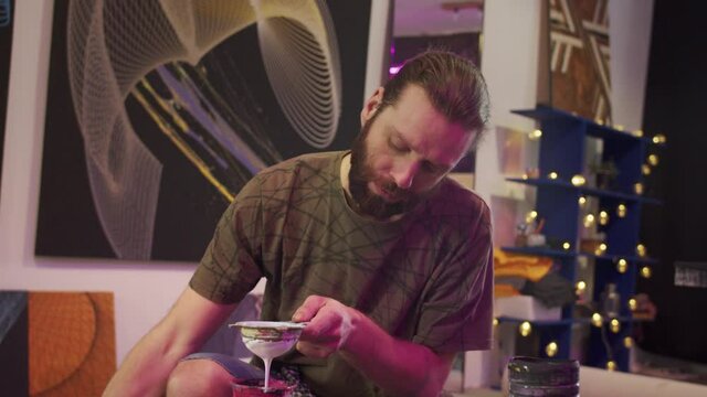 A talented painter is filtering paints 