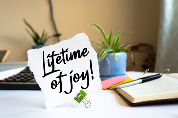 Text lifetime of joy on the short note texture background