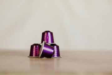 Purple espresso coffee capsules, pods on plain background