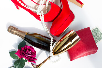 red women's shoes and champagne. Wallet with a bill