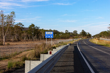 Curving Peak Downs Highway near Nebo with koala and wildlife protection fencing on both sides and a...