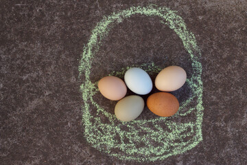 Farm eggs in a drawn basket top view. Healthy food concept.