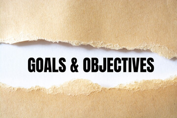 Goals and Objectives words written under torn paper.