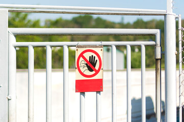 Command no enter. The sign of entry ban on the white iron gate. Forbidden territory.