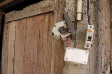 Old house with bad installation of the switchboard and scorched's. High voltage electrical burn...