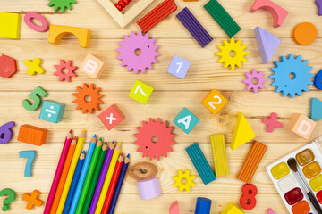 Colorful math fractions, cubes, pencils on wooden table. Interesting mathematics for kids. Education, back to school concept