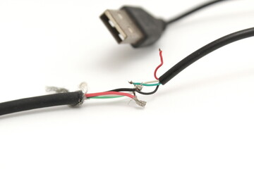 The mouse eats the black data cable. Broken USB cable solated on a white background