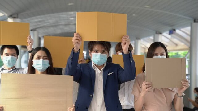 Group of activists with banners protesting to democracy and equality. Men and women doing a silent protest for democracy and equality
