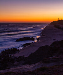 Waves crashing along the Malibu coast at sunset in Leo Carrillo Park