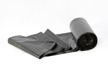 Black Polyethylene Garbage Bags on White Background - Close-Up. The Roll of Plastic Junk Package