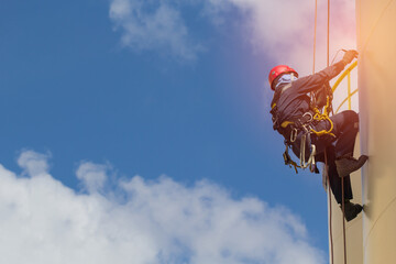 Male worker rope access  inspection tank oil