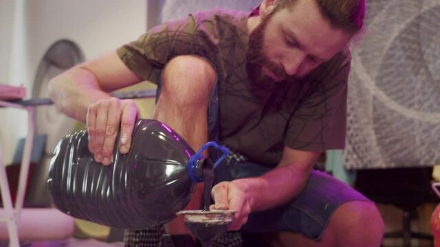 A talented painter is filtering paints 