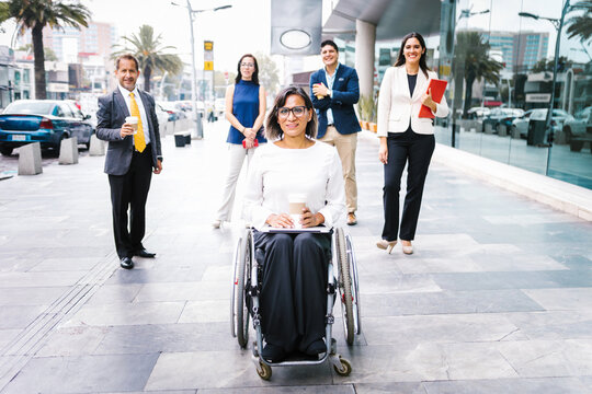 Latin disabled transgender female and her business team taking coffee break, in disability concept and disabled people