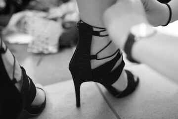 Close up on women's high heels shoes.