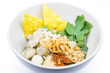 Thai style spicy instant noodles soup in bowl, Tom Yum with Thai herbs, Thai food, Noodle soup on white background.