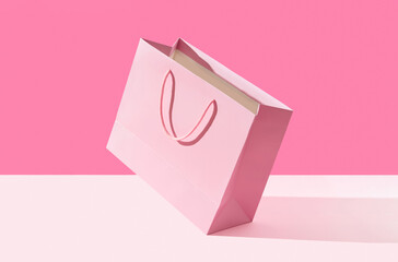Paper shopping bag on pink background. Shopping sale delivery concept