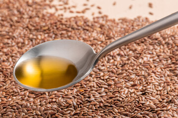 Flax seed oil is in a spoon. Close-up.