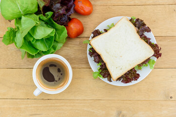 top view of Sandwich tuna in white dish with hot coffee