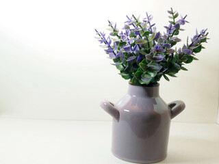 Picture of artificial plastic flower on a ceramic vase