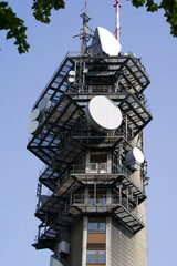 Close-up of communications tower at local mountain Uetliberg Felsenegg on a sunny summer day. Photo taken June 18th, 2021, Zurich, Switzerland.	