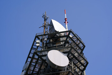 Close-up of communications tower at local mountain Uetliberg Felsenegg on a sunny summer day. Photo taken June 18th, 2021, Zurich, Switzerland.	