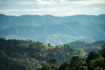 green mountains with thin smoke