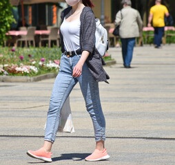 Young woman walks on the street