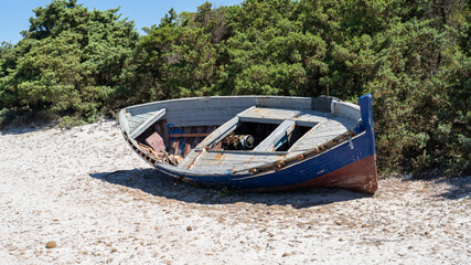 Naklejka na ściany i meble Boat abandoned on Italian beaches by immigrants who crossed the Mediterranean Sea. Migrants who come from African countries