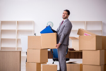 Young male employee in relocation concept