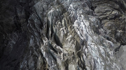 Fototapeta na wymiar Caucasus, Ossetia. Tsey gorge. Cracks in the icefall. 